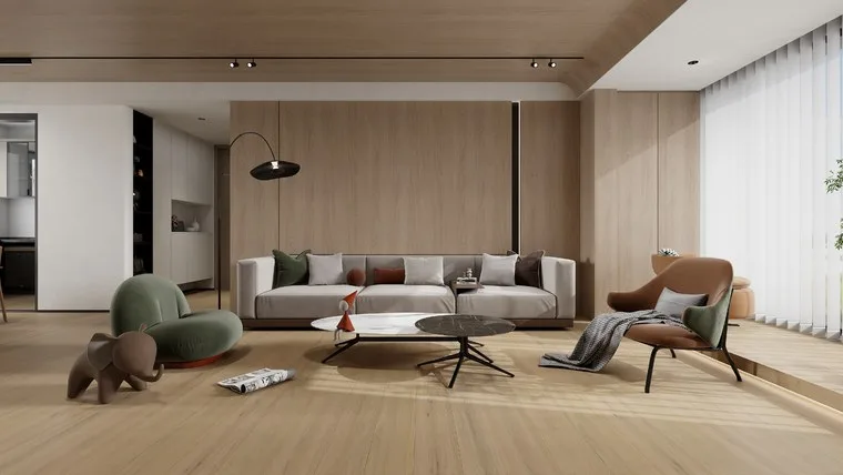 Wood flooring in a living room with a grey sectional sofa and sculptural chairs