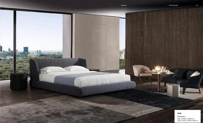 Bedroom with a charcoal upholstered bed and a small round dining table