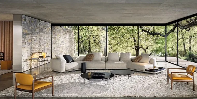 Living room with a light grey sectional sofa and mustard leather armchairs
