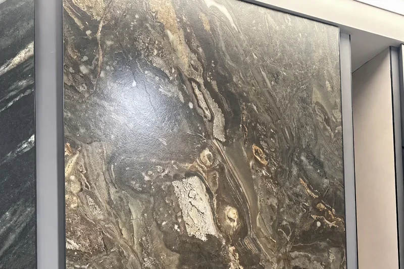 Large porcelain slab with brown, black and cream veining displayed upright