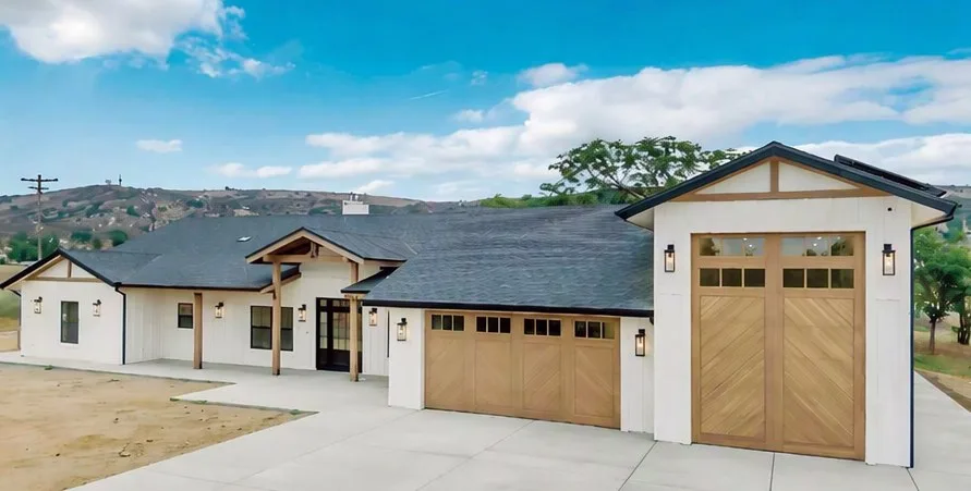 Wood-finish aluminium garage doors on a ranch-style house