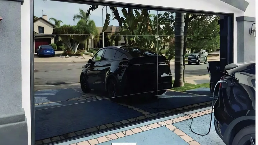 Full-glass aluminium sectional garage door with an electric car charging